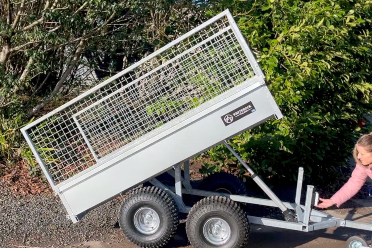 Trailer bed angled in tipping action.