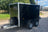 Front and side view of a twin axle black boxxa. It has a jockey wheel and front mounted spare wheel.