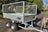 Angled view of galvanised steel trailer with mesh sides .