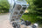Front view of a galvanised steel trailer in full tipping position.