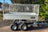 Full side view of a galvanised 4 wheeled trailer with mesh sides