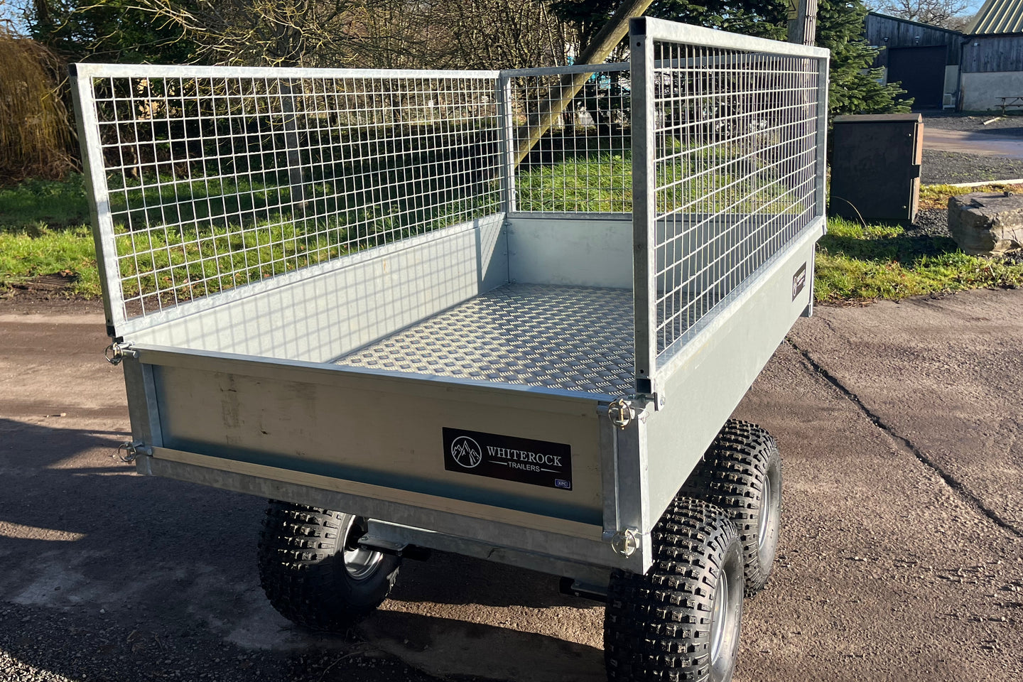 Rear view of galvanised steel trailer with mesh sides and aluminium flooring.