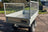 Rear view of galvanised steel trailer with mesh sides and aluminium flooring.