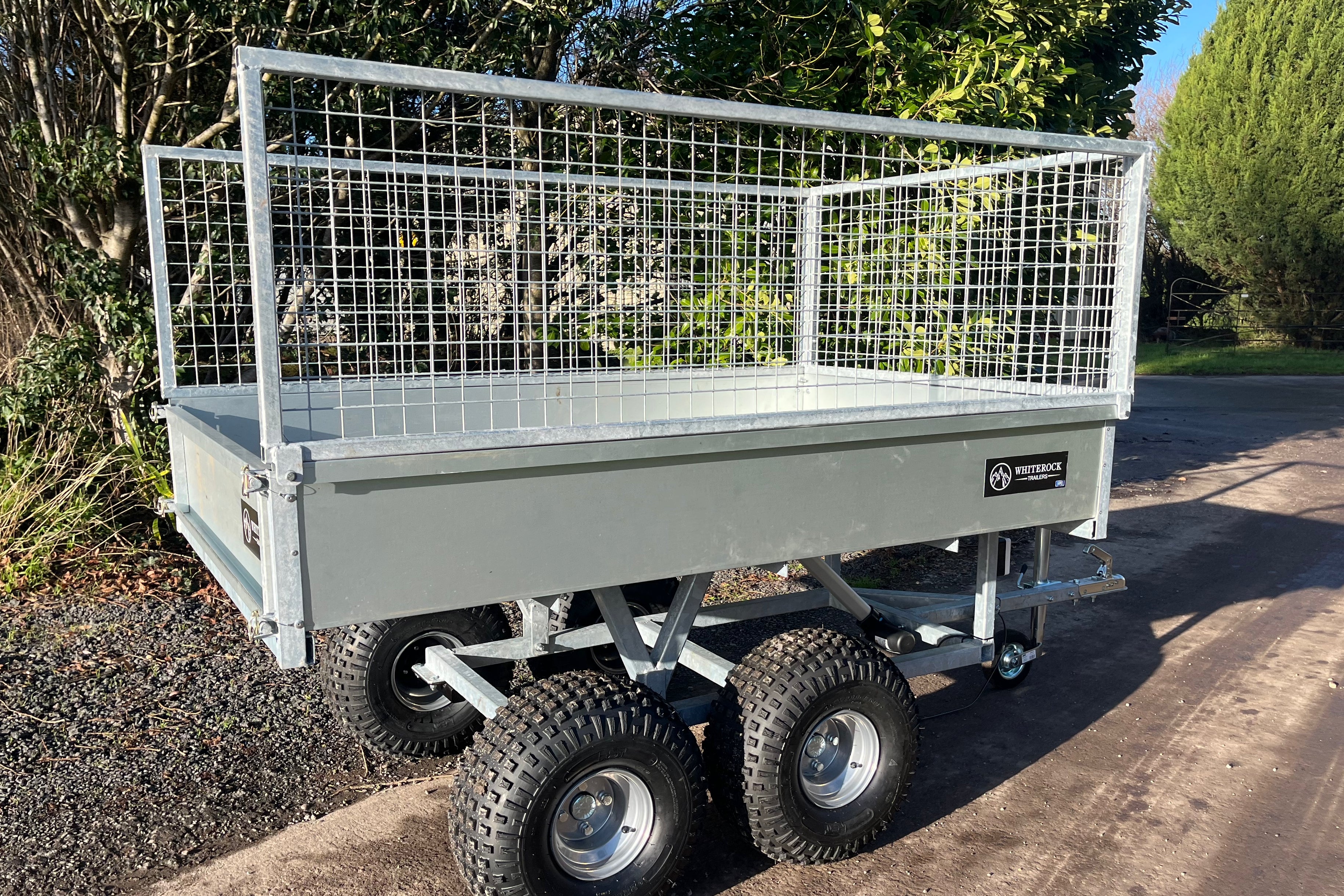 Galvanised steel trailer with mesh sides and view of rear gate.