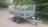 Video of a tipping trailer with mesh sides, showing the full range of tipping motion.