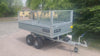 Video of a tipping trailer with mesh sides, showing the full range of tipping motion.